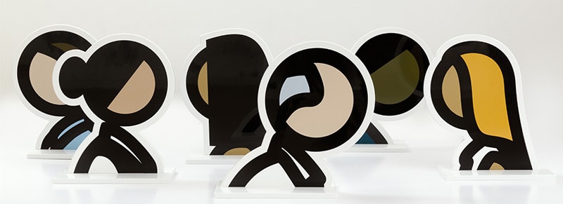 Six minimalist pop sculptures of people's heads