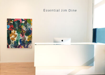 Image of front desk in gallery with abstract Jim Dine painting in the background