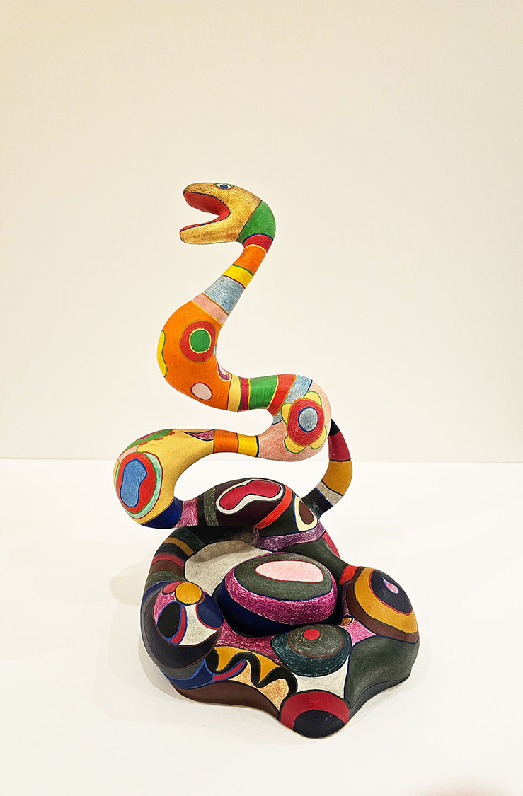 Small sculpture of a snake and an egg in a nest by Nikki de St. Phalle
