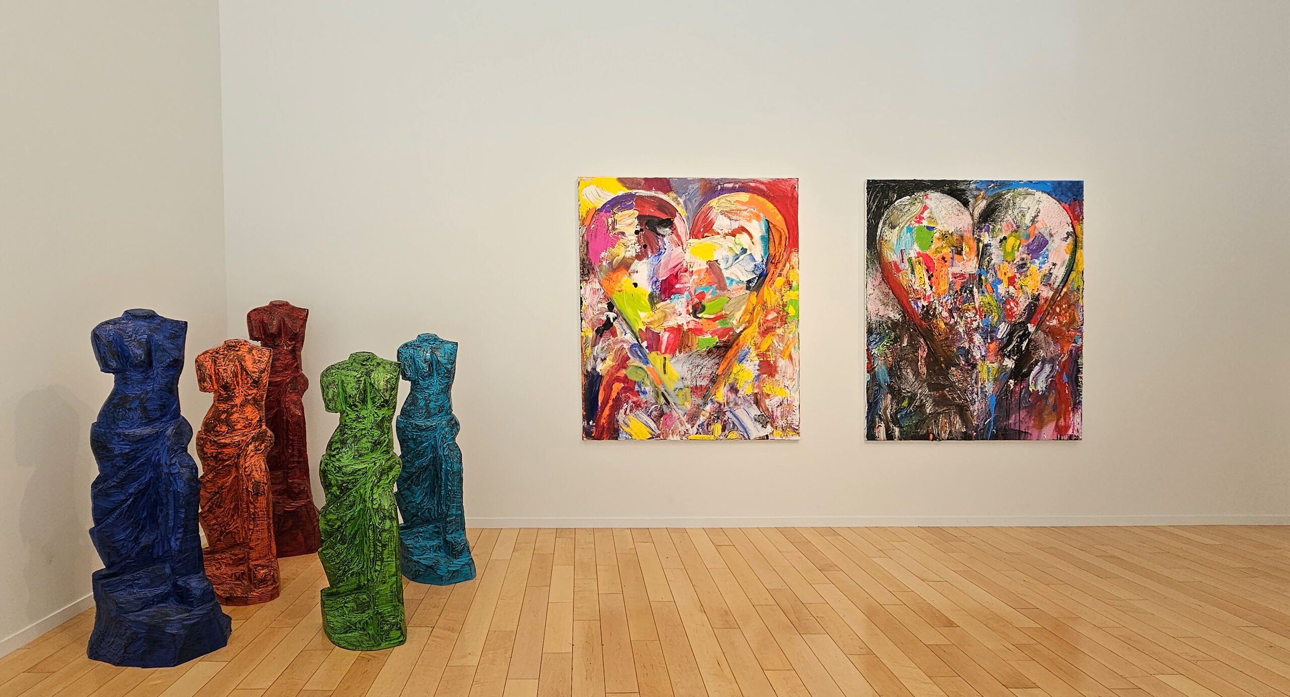 Gallery installation shot with five-part sculpture of Venuses and two paintings of hearts by Jim Dine